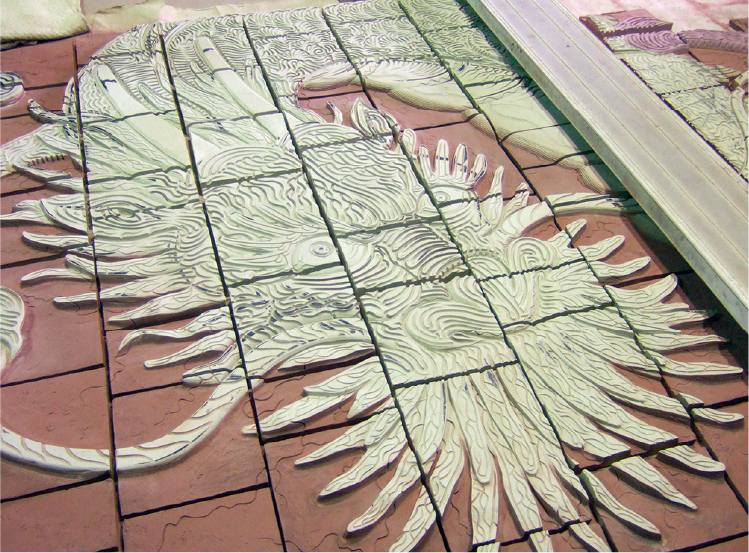 Glazing Work (after the clay has dried, glaze is sprayed on the background)