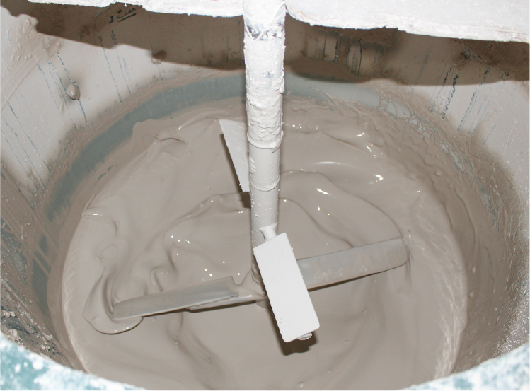 Combine the clay and water in a mixer to make a slurry.