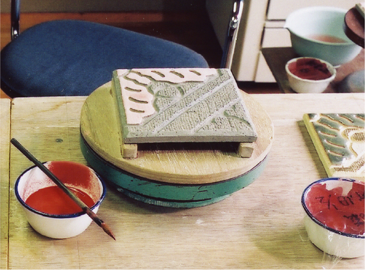 After drying, apply a thick layer of celadon glaze to the oak section